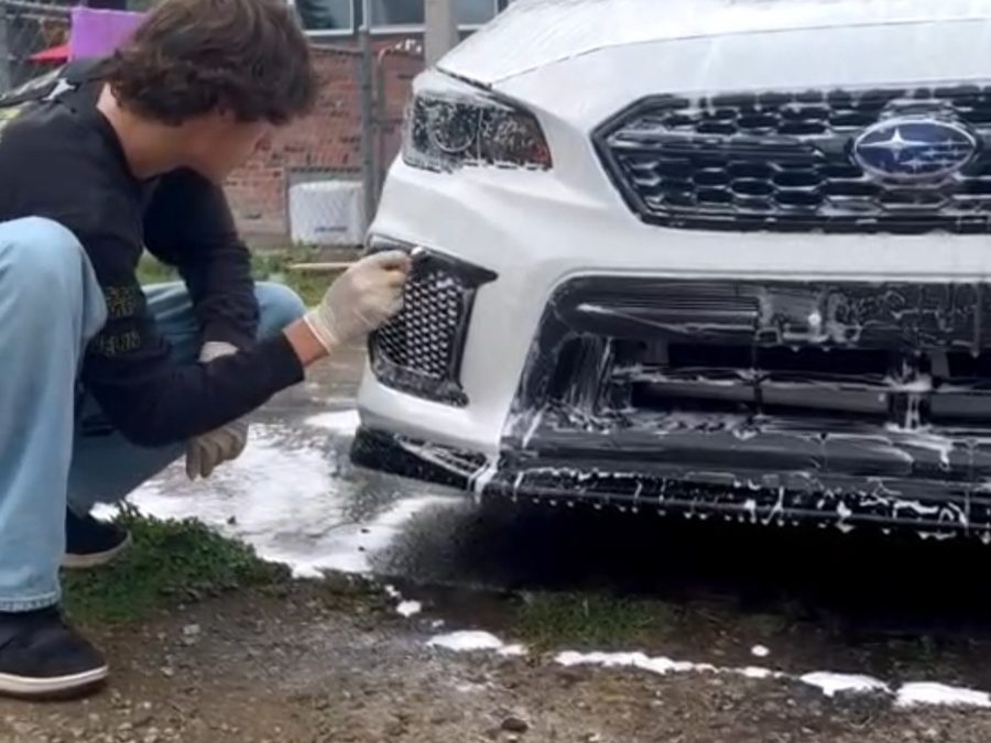 ElichAuto detailing a vehicle front bumper — close-up exterior work in progress